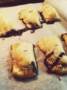 blackberry hand pies, hot from the oven, on parchment paper